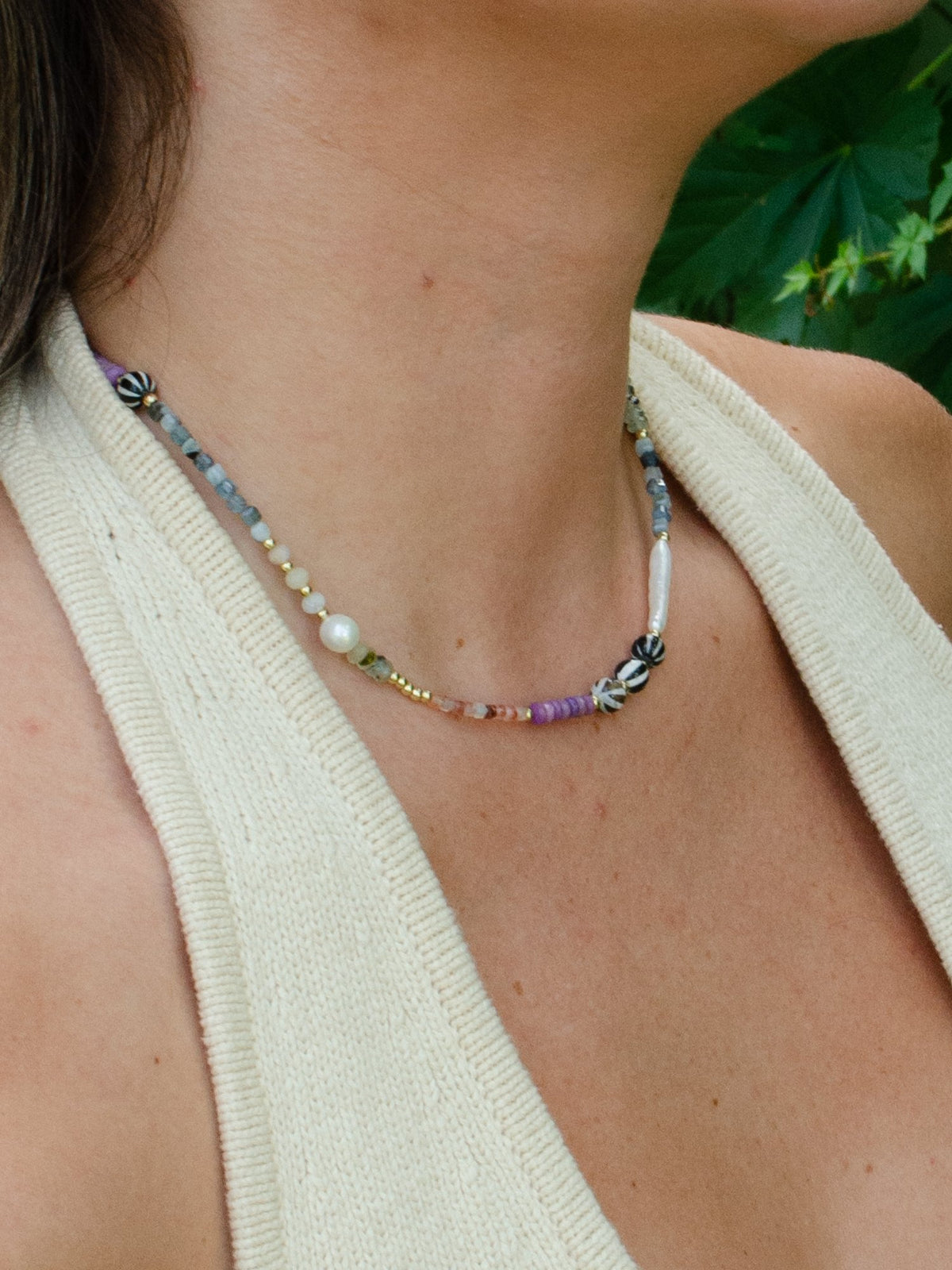 Close up of baby gems necklace and freshwater pearl on model