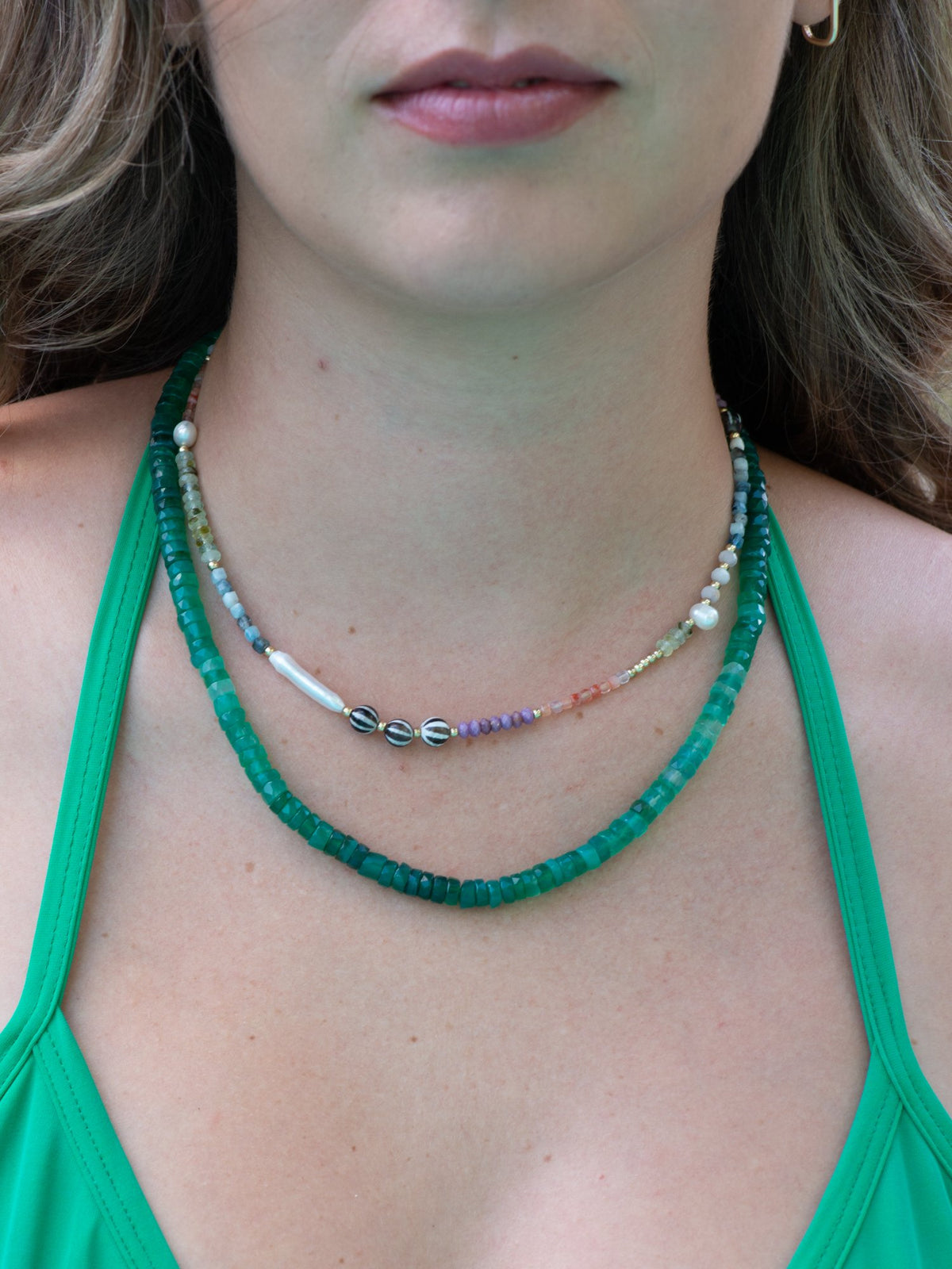 Close up of baby gems necklace with freshwater pearl and viridis gradient chalcedony necklace on model