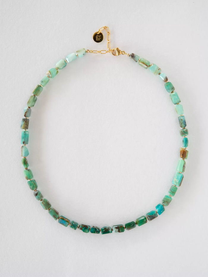 Necklace with green opal beads on a white background
