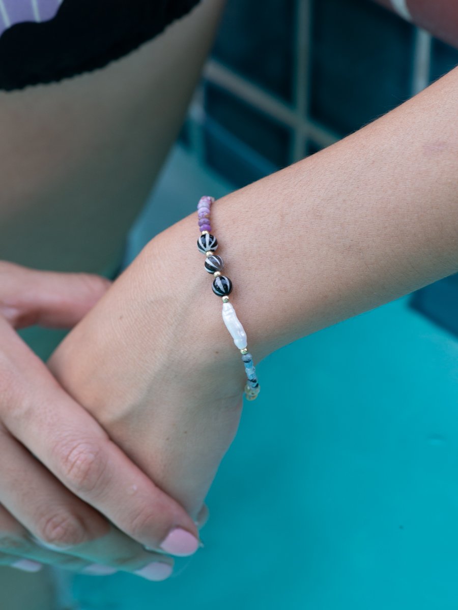 Model wearing baby gems bracelet by pool