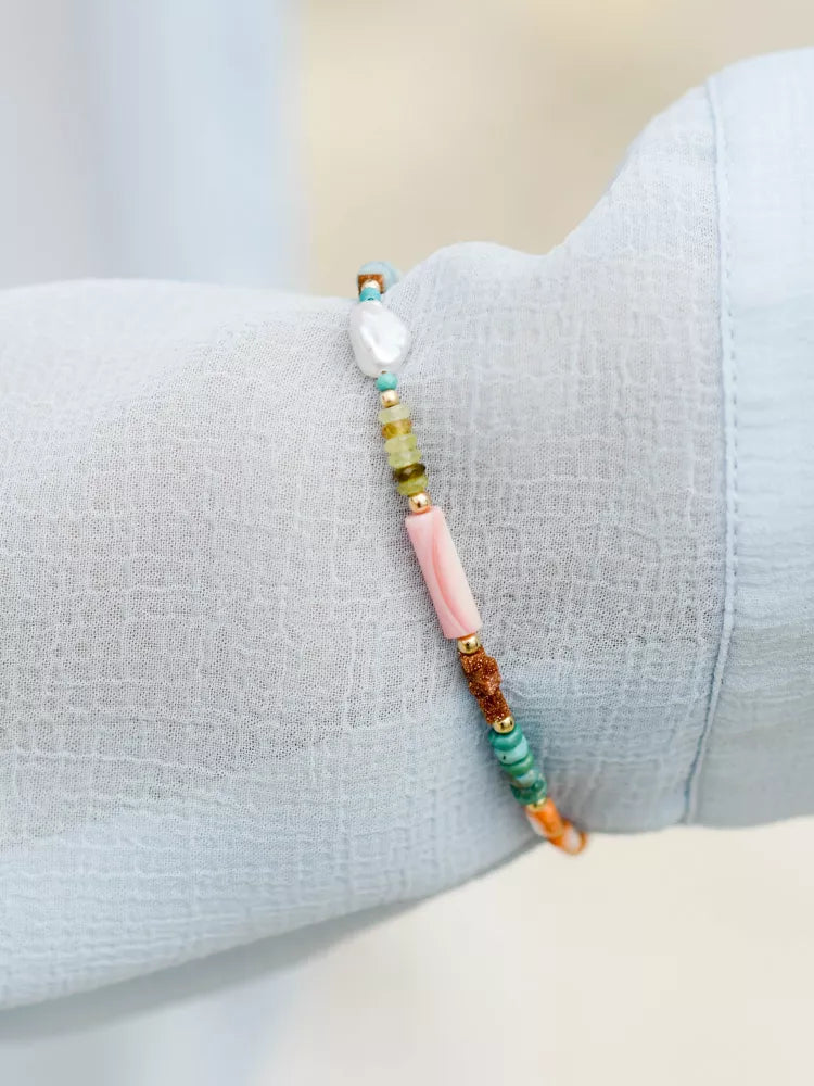 Multicolored beaded bracelet on a light gray surface