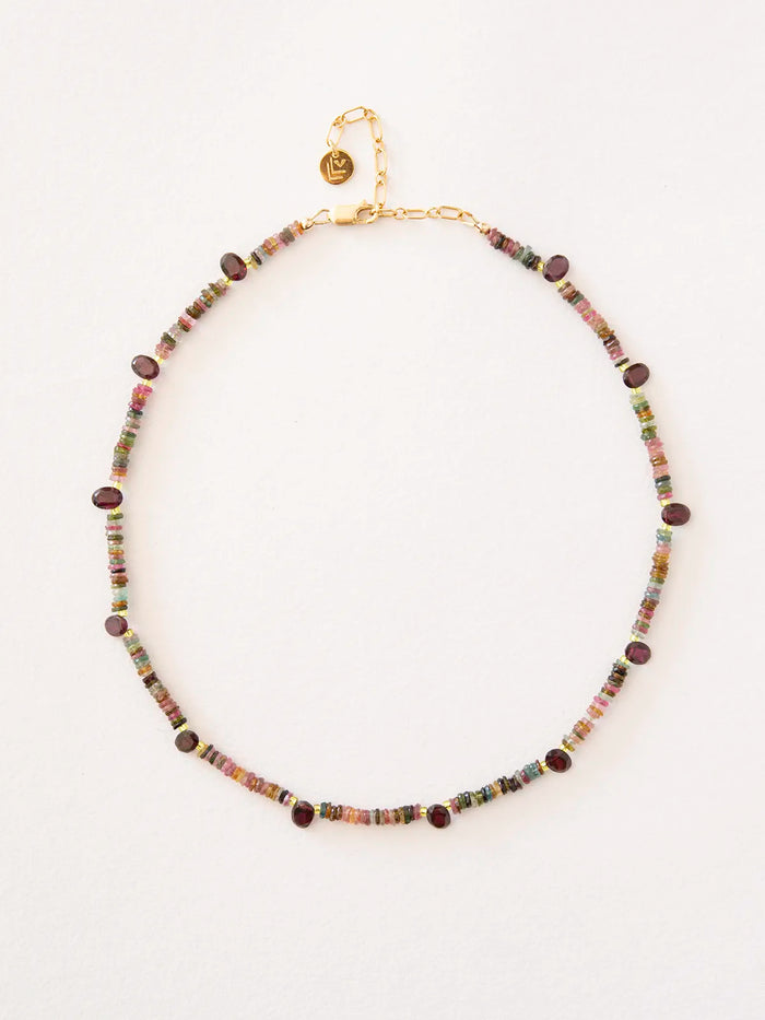 A beaded necklace featuring small multicolored cylindrical beads with dark reddish-brown oval accents, connected by gold-filled chain and clasp, displayed on a clean white background.