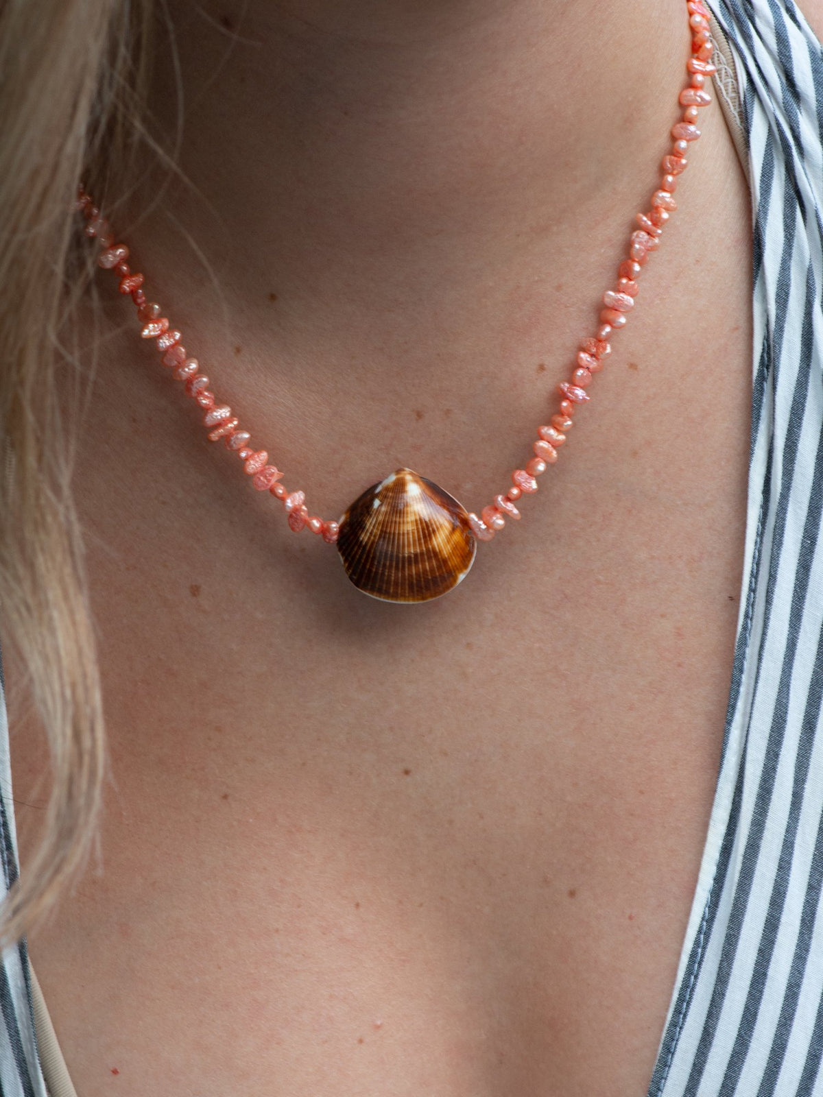 Close up of beachcomber shell necklace on model