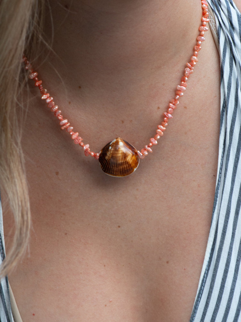 Close up of beachcomber shell necklace on model