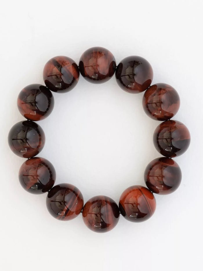 Red tigers eye beaded bracelet on a white background