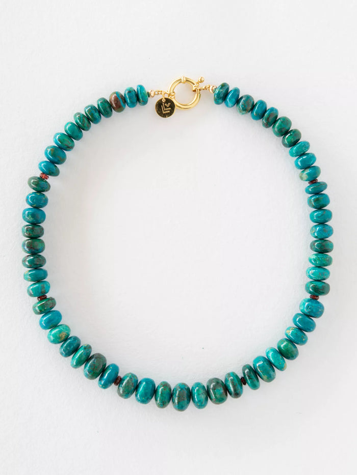 Turquoise beaded necklace with a gold clasp on a white background