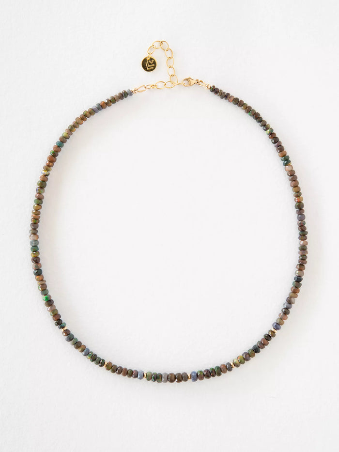 Necklace with opal and gold beads on a white background