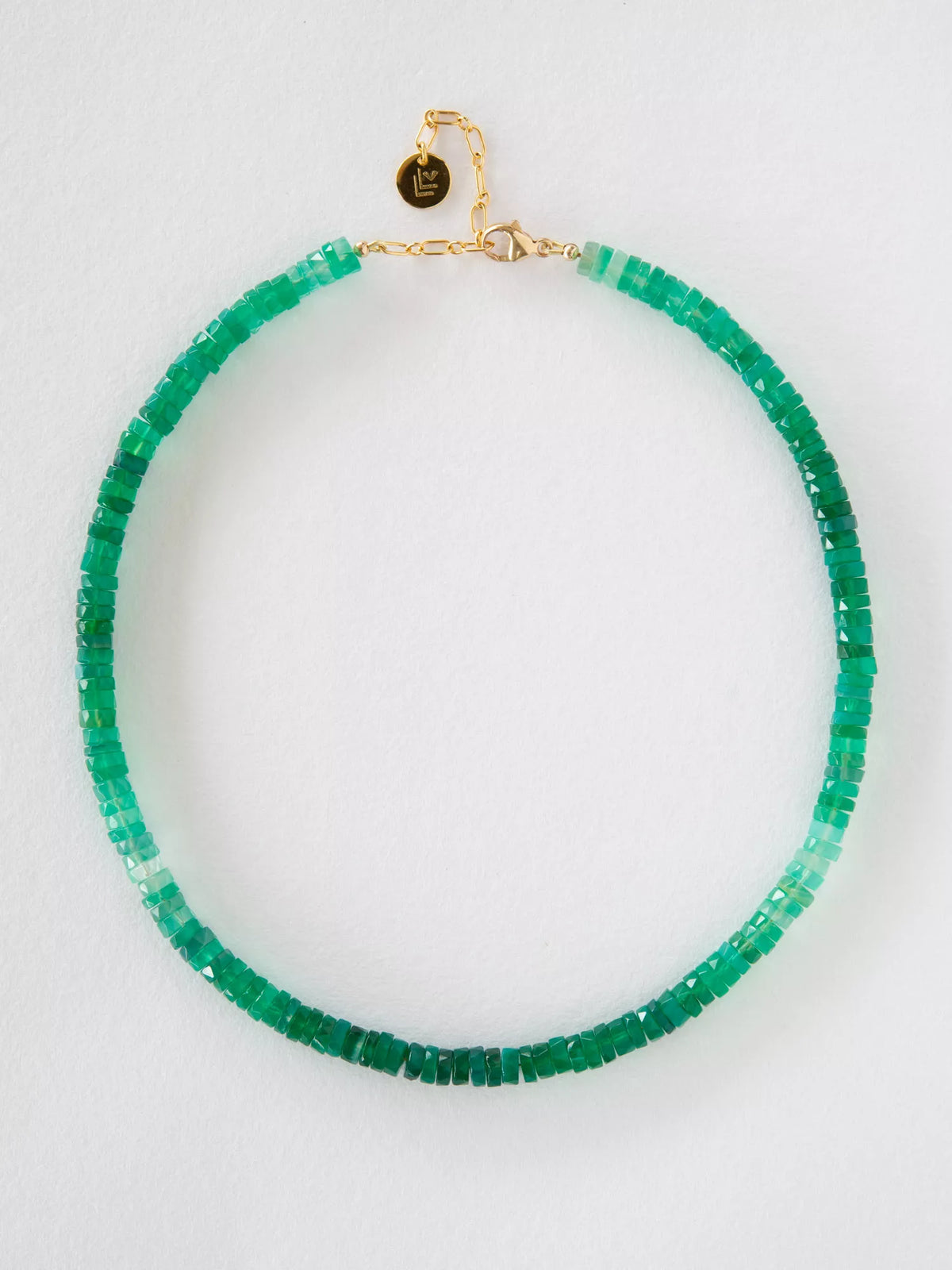 Green beaded necklace with a gold clasp on a white background