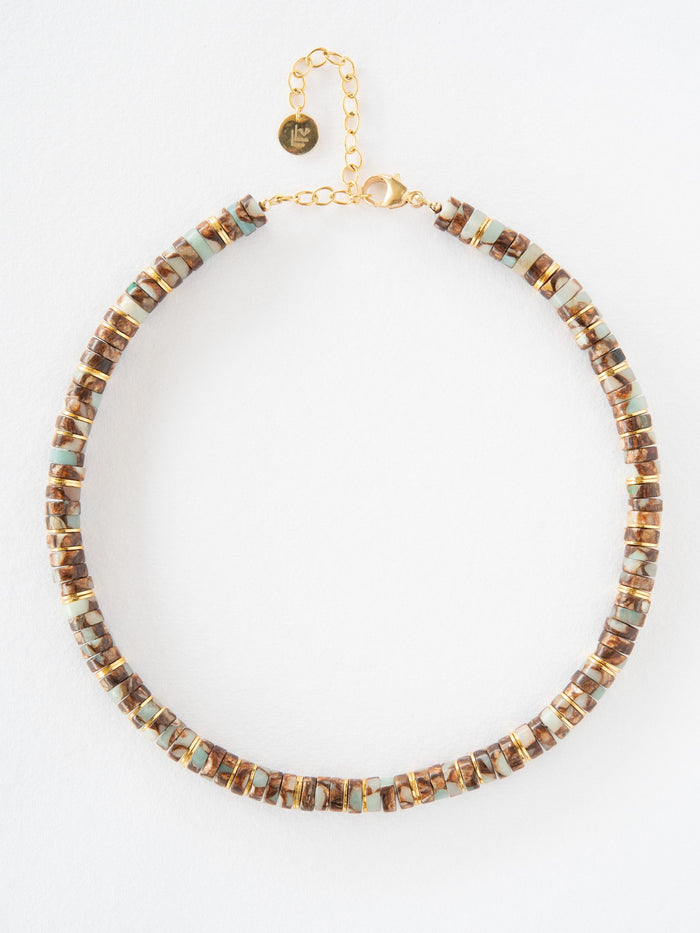 Necklace with brown and gold beads on a white background