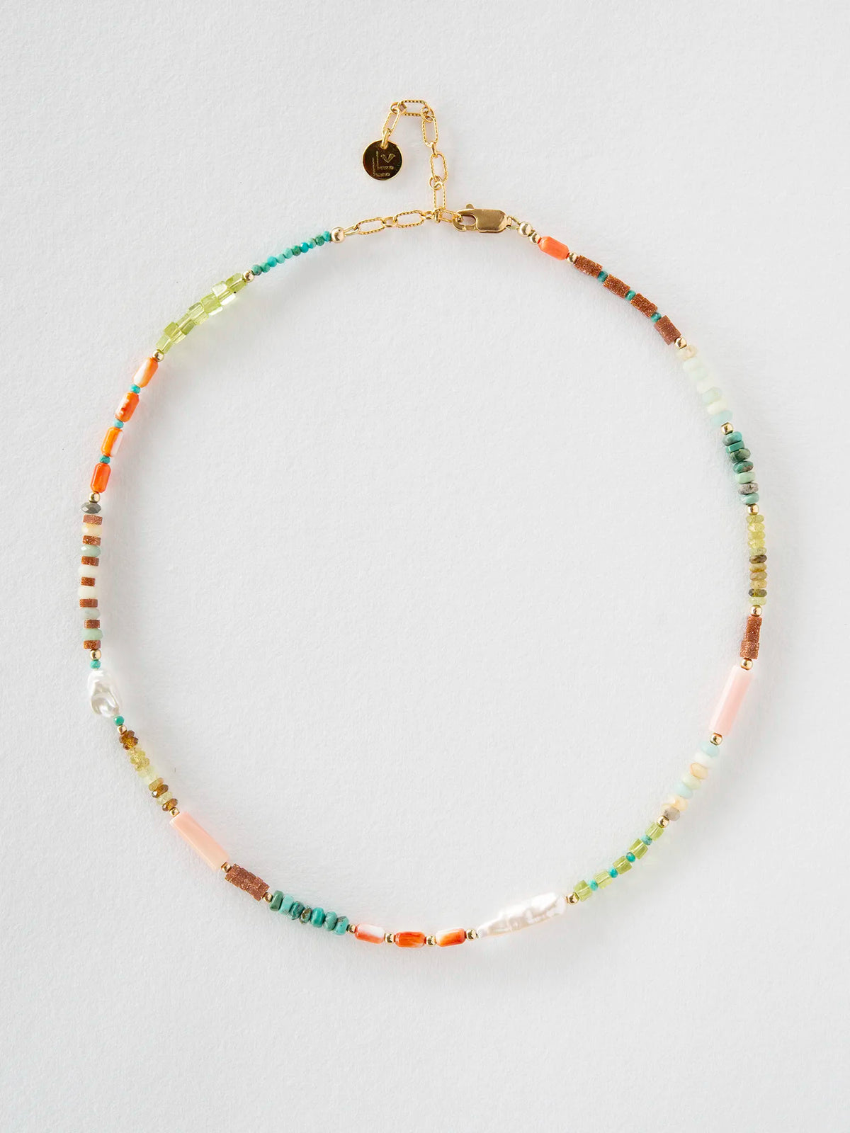 A beaded necklace with a gold-tone chain and clasp, featuring a mix of colorful spacer beads including turquoise, orange, pink, green, and brown, displayed on a light gray background.