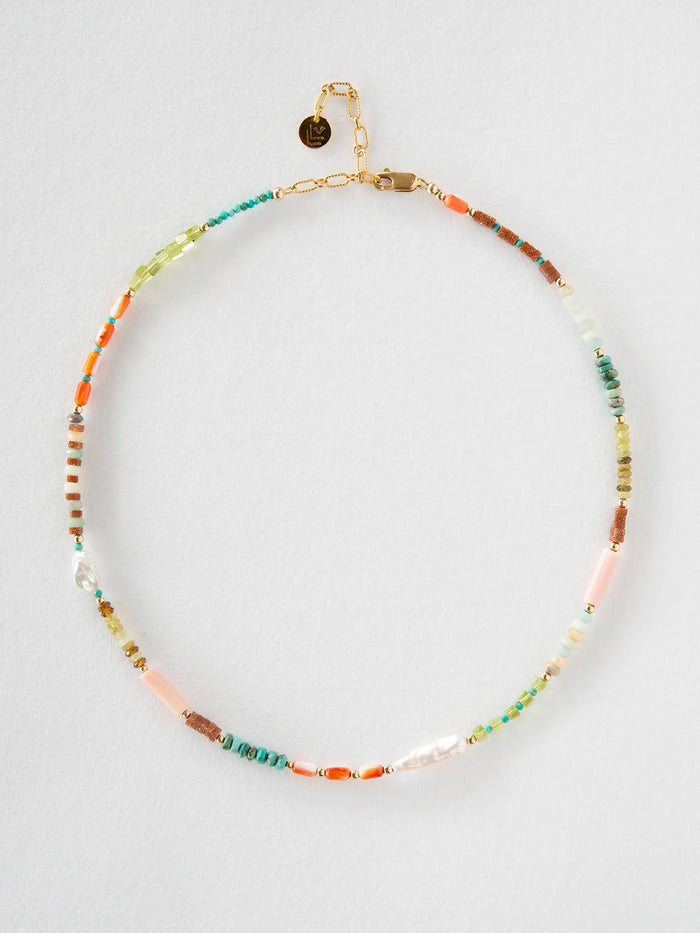 A beaded necklace with a gold-tone chain and clasp, featuring a mix of colorful spacer beads including turquoise, orange, pink, green, and brown, displayed on a light gray background.