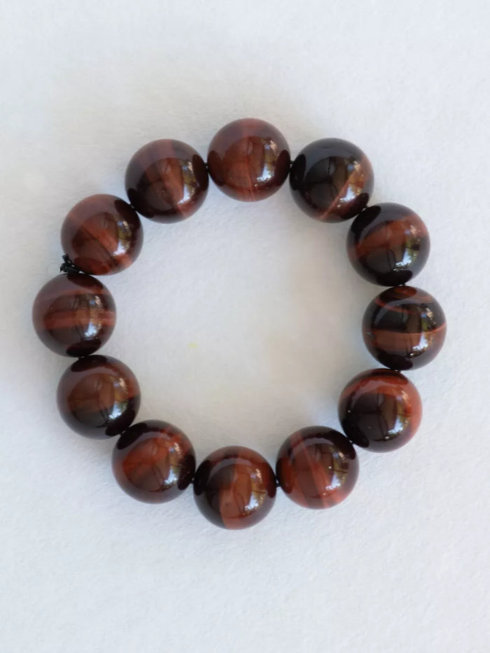 Bracelet with brown beaded design on a white background