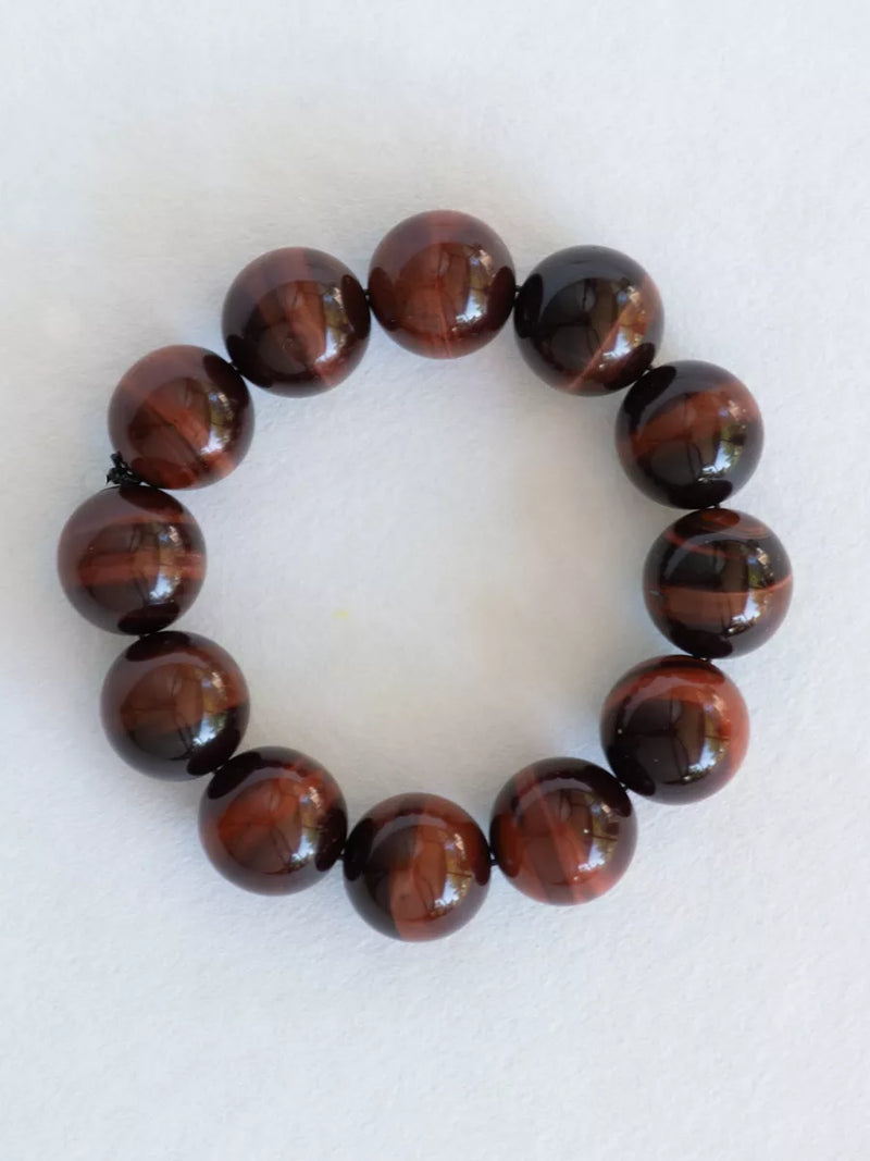Bracelet with brown beaded design on a white background