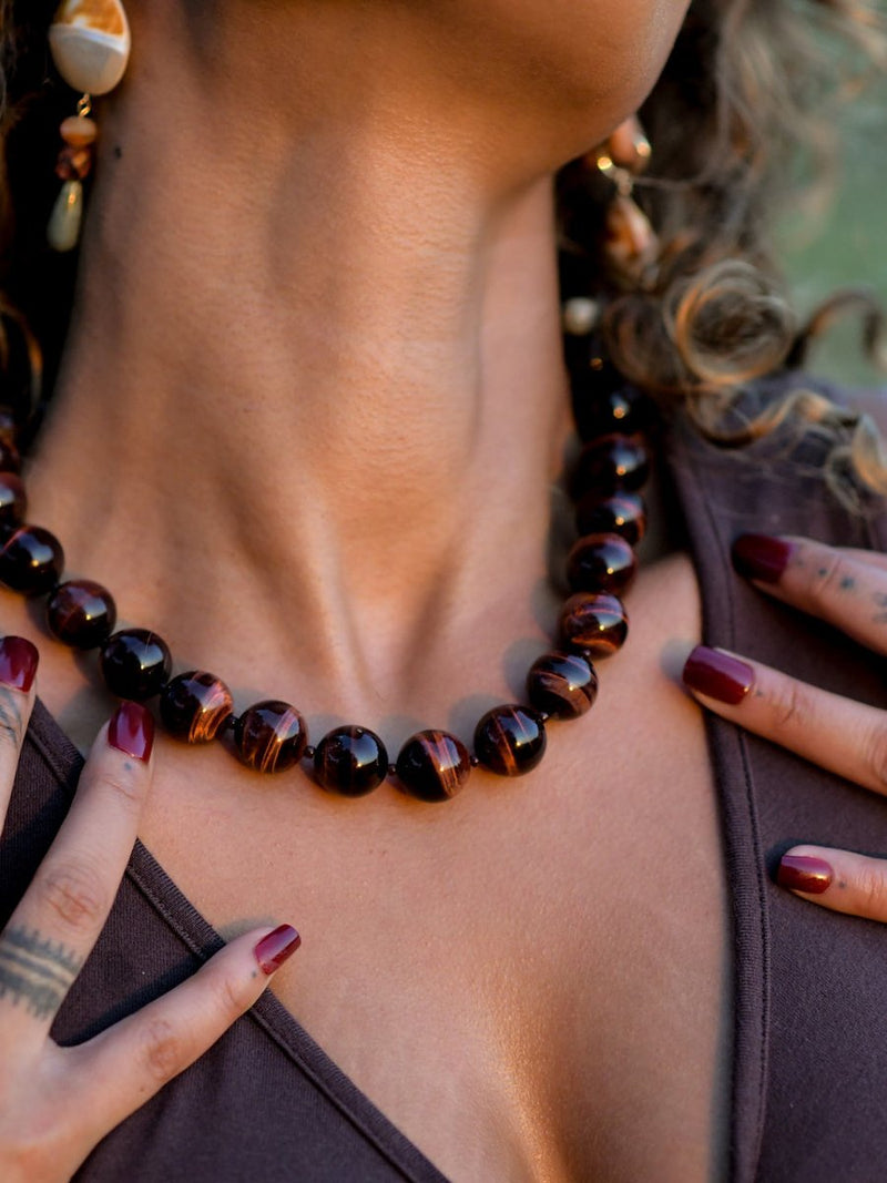 Close up of model wearing Black Cherry Tiger's Eye necklace.