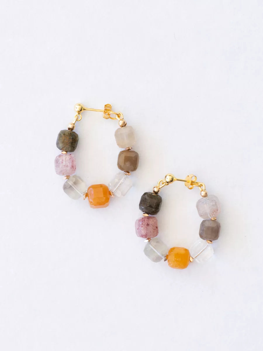 Pair of hoop earrings with multicolored beads on a white background