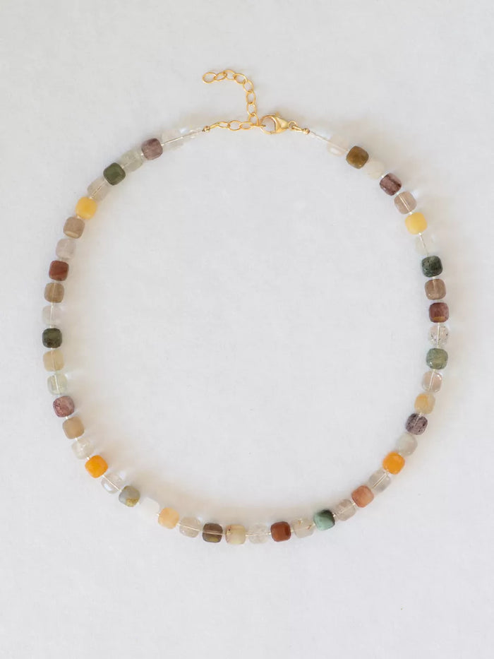 Phantom quartz block necklace flat lay on a white background.