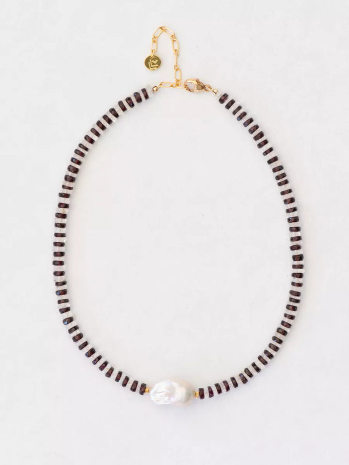 Necklace with garnet and crystal beads on a light gray background