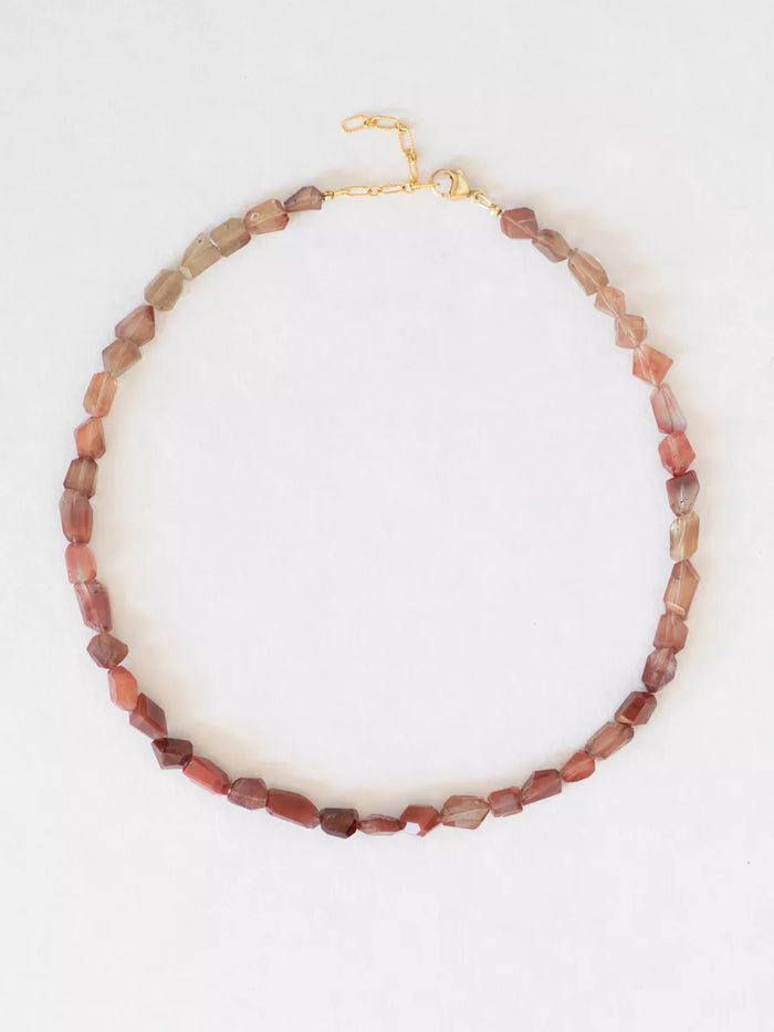 Heartstone Gradient Andesine Necklace flat lay.