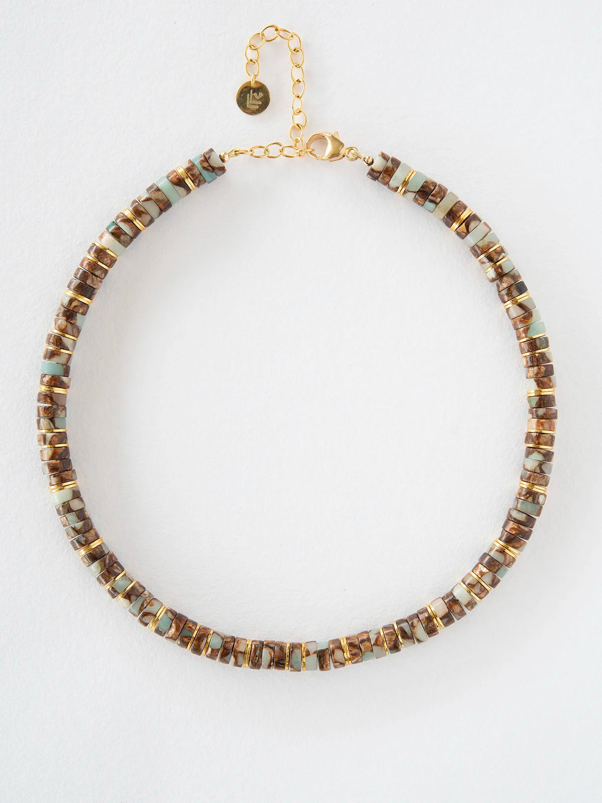A gold-tone beaded necklace with alternating brown and light blue-green rectangular beads, displayed on a clean white background.