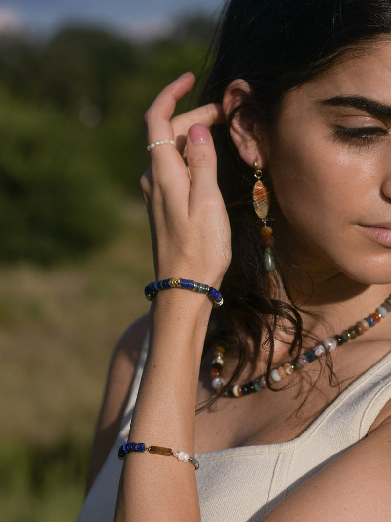 Model wearing a lapis heishi stretch bracelet and Lux Baby Gems bracelet.