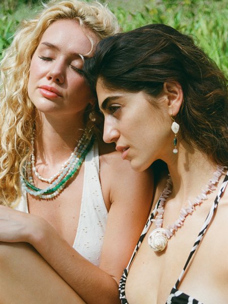 Models wearing necklaces in the grass