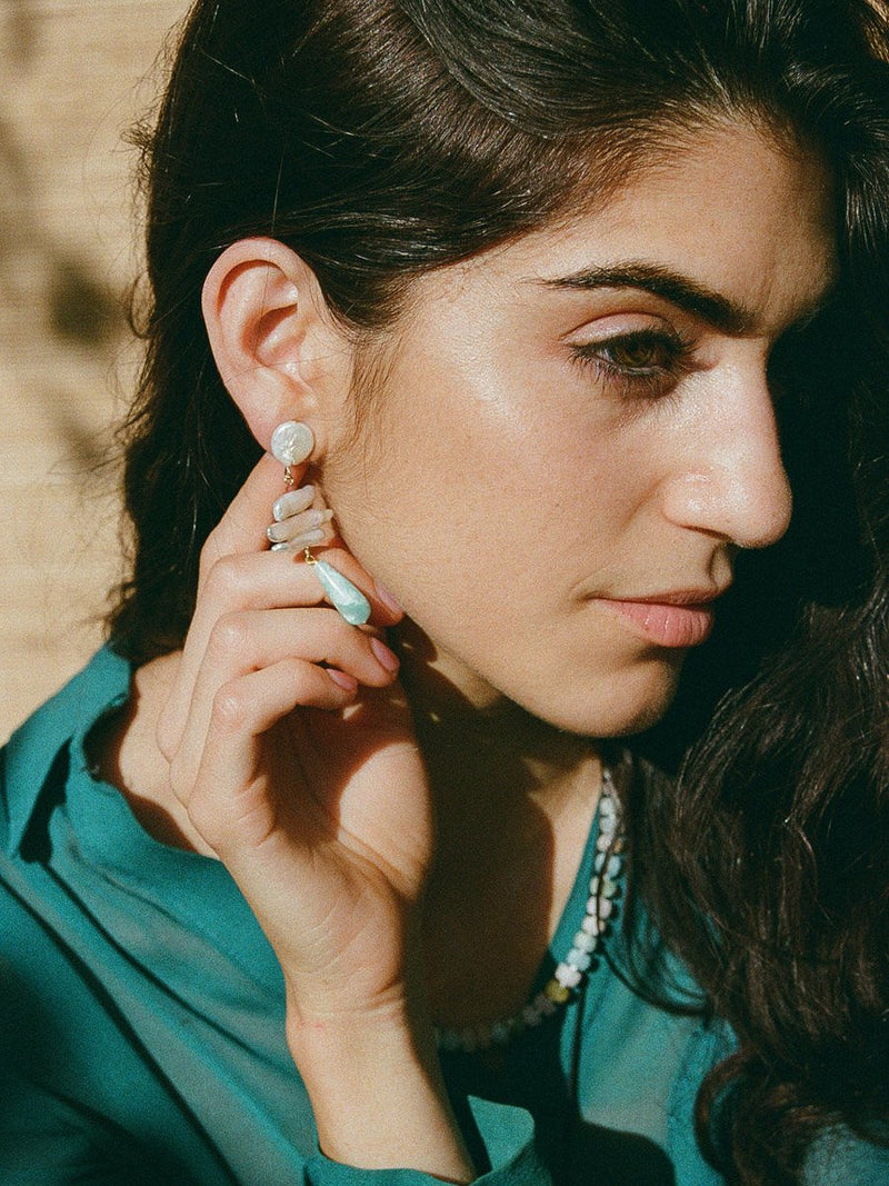 Woman wearing earrings with a blurred background