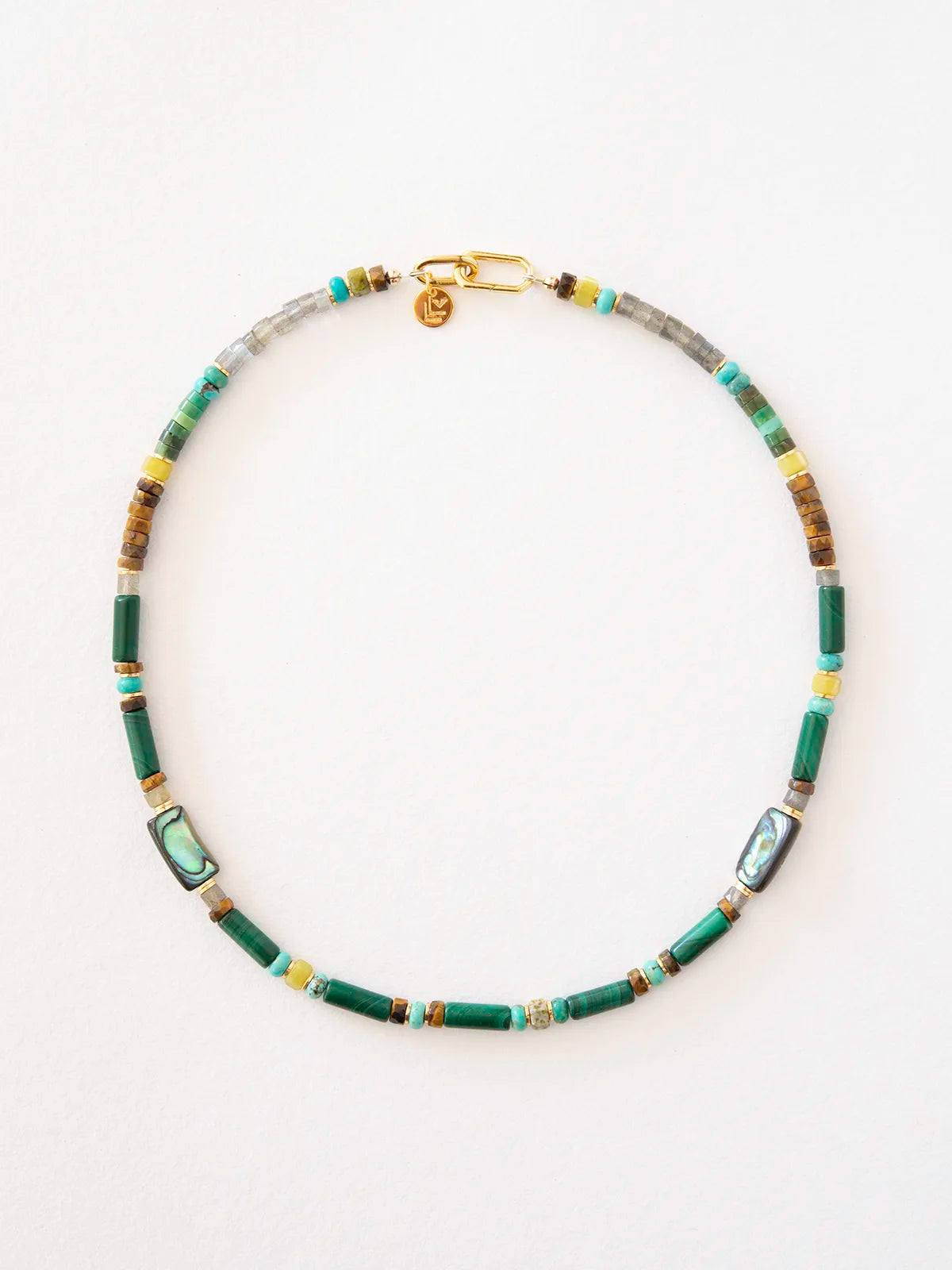 A beaded necklace featuring green cylindrical beads, rectangular abalone shell inlays, turquoise beads, and small gold spacer beads, arranged in a circle on a white background.