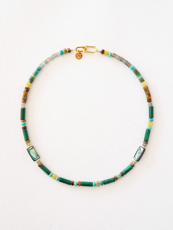 A beaded necklace featuring green cylindrical beads, rectangular abalone shell inlays, turquoise beads, and small gold spacer beads, arranged in a circle on a white background.
