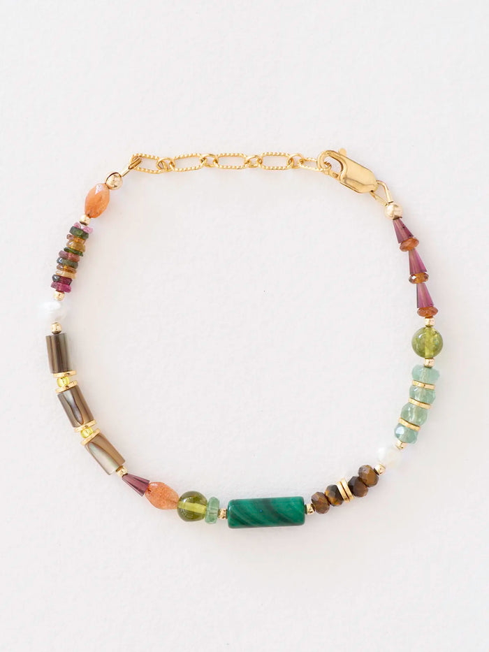 A beaded bracelet with a gold chain and clasp, featuring a mix of colorful gemstone beads including green, brown, purple, orange, and white, displayed on a clean white background.