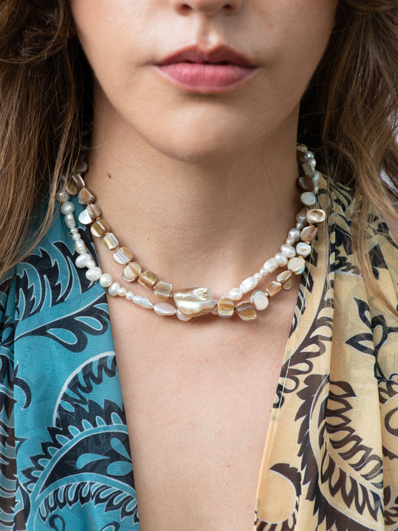 Close up of pearl collective necklace and nacre by nature choker necklace on model 3