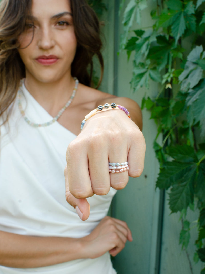 Model wearing pearl stretch rings