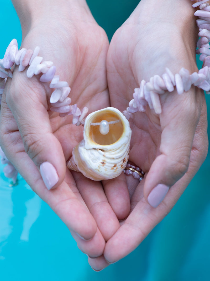 Model showing secret pearl in turbo shell necklace
