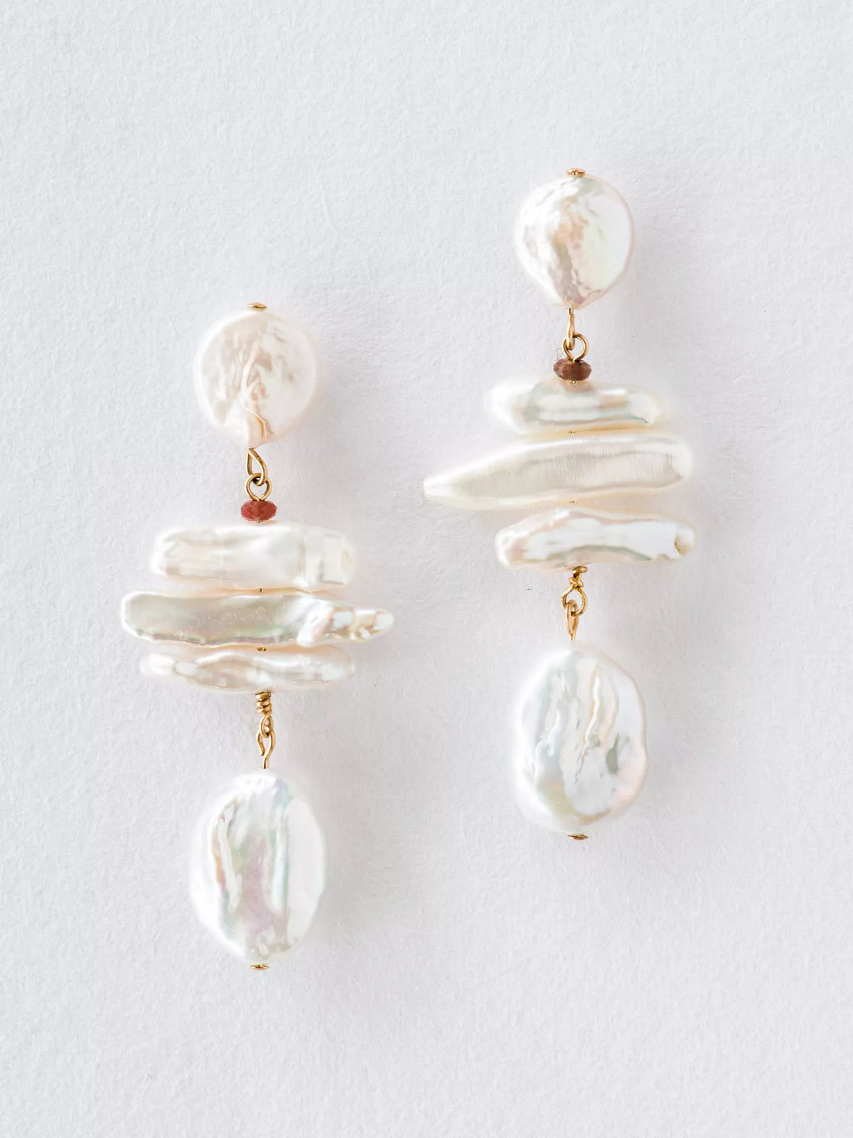 Pair of pearl earrings on a light gray background
