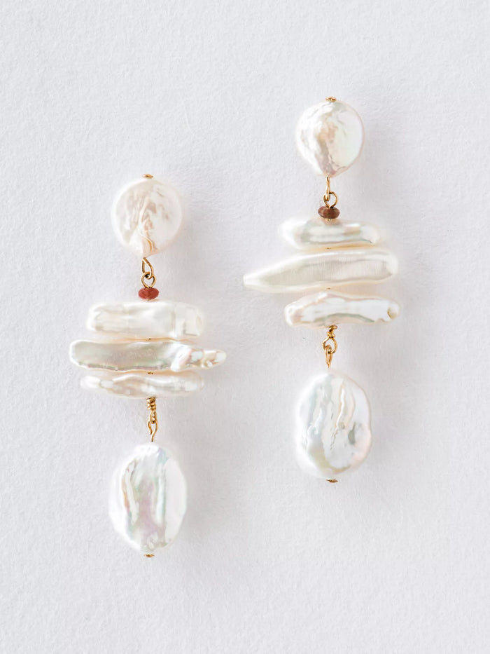 Pair of pearl earrings on a light gray background