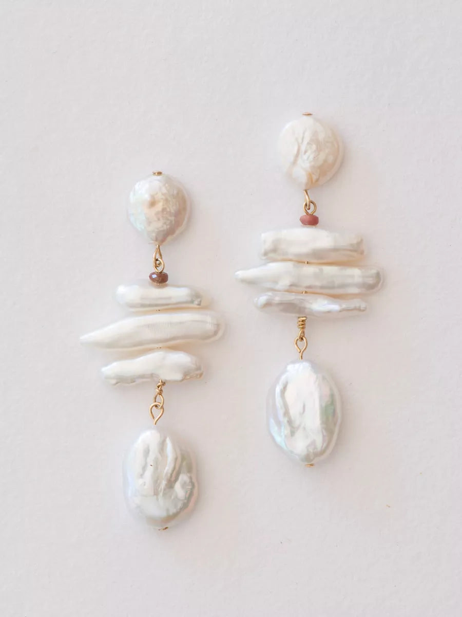 Pair of pearl drop earrings on a light background