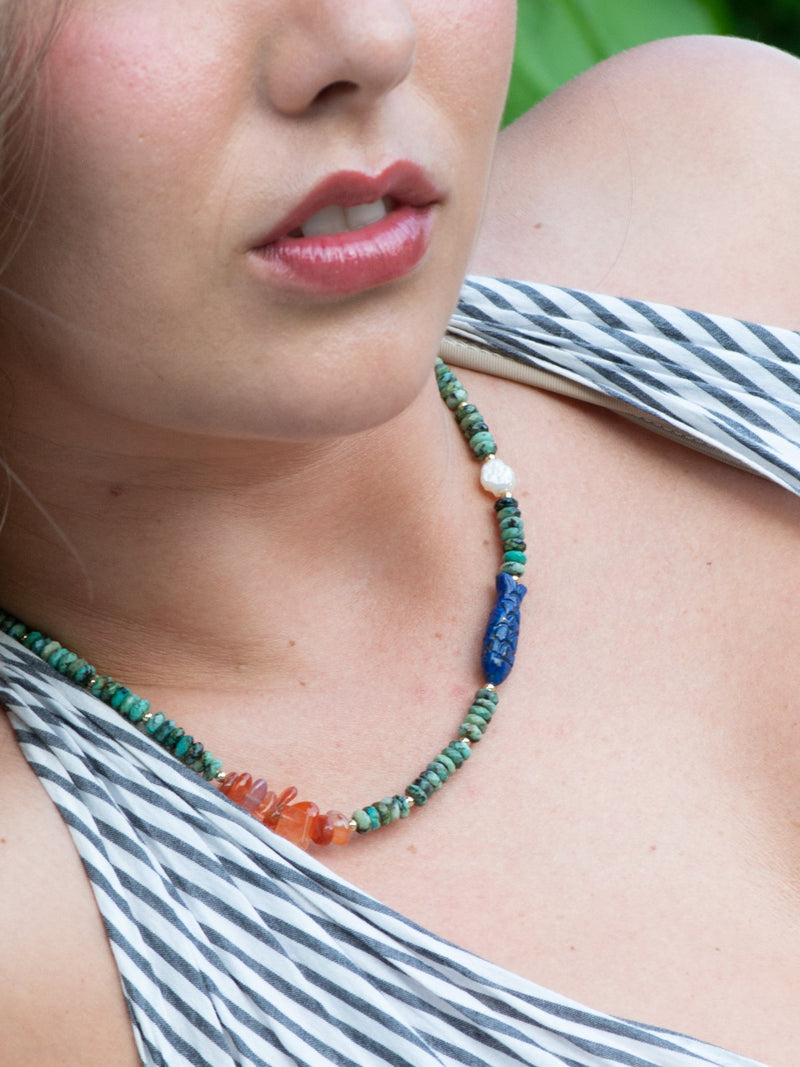 Close up of model wearing thalassophile turquoise necklace