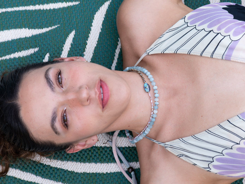 Tide pool vintage pearl and abalone a blue skies aquamarine necklaces on model by pool