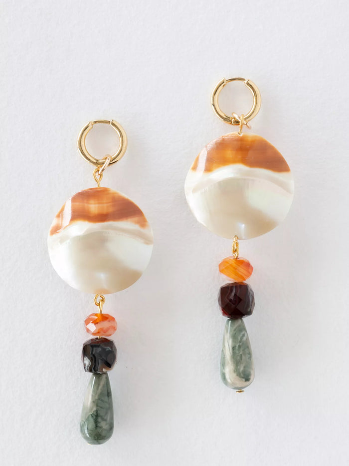 Pair of earrings with marbled beads and colorful drops on a white background