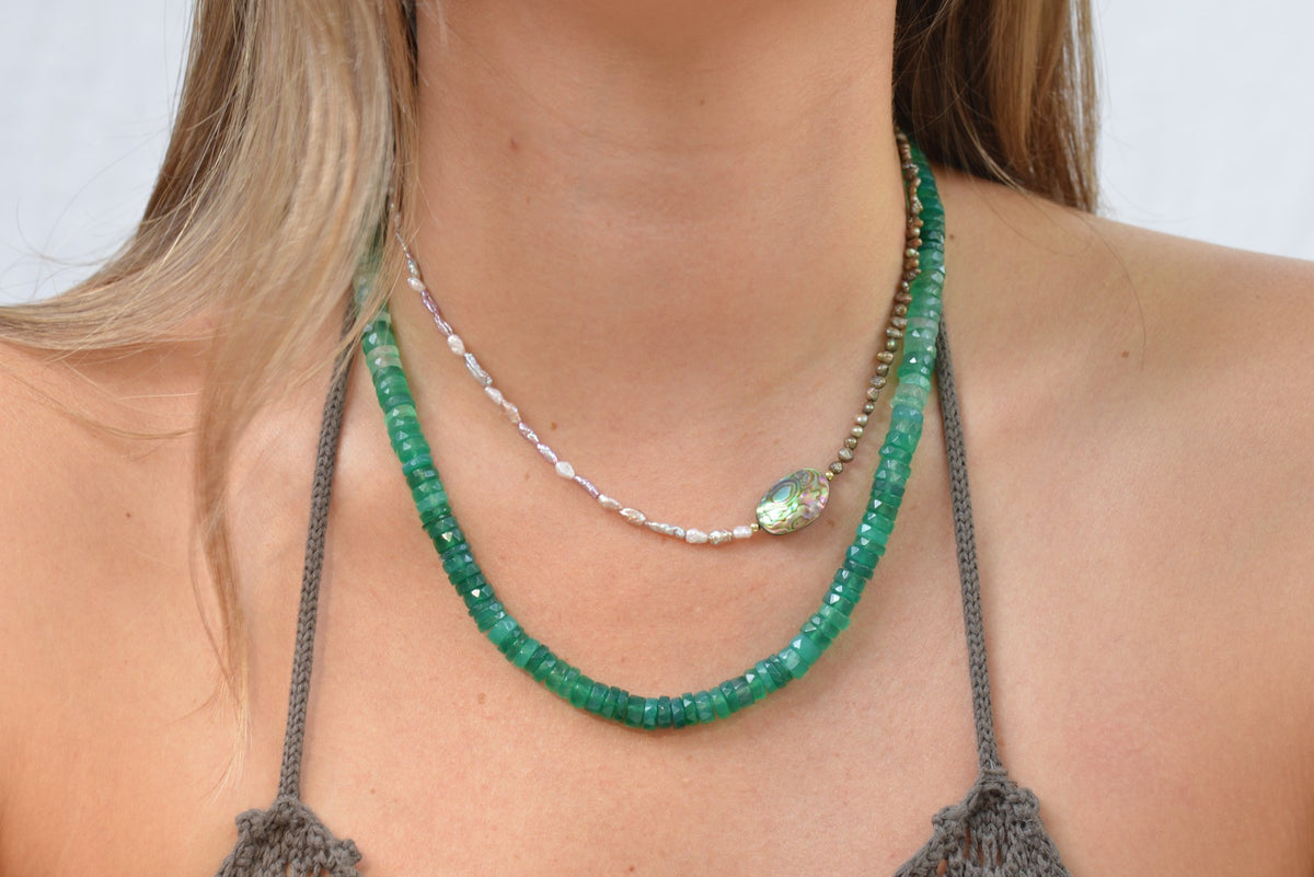 Close up of model wearing viridis gradient chacedony necklace